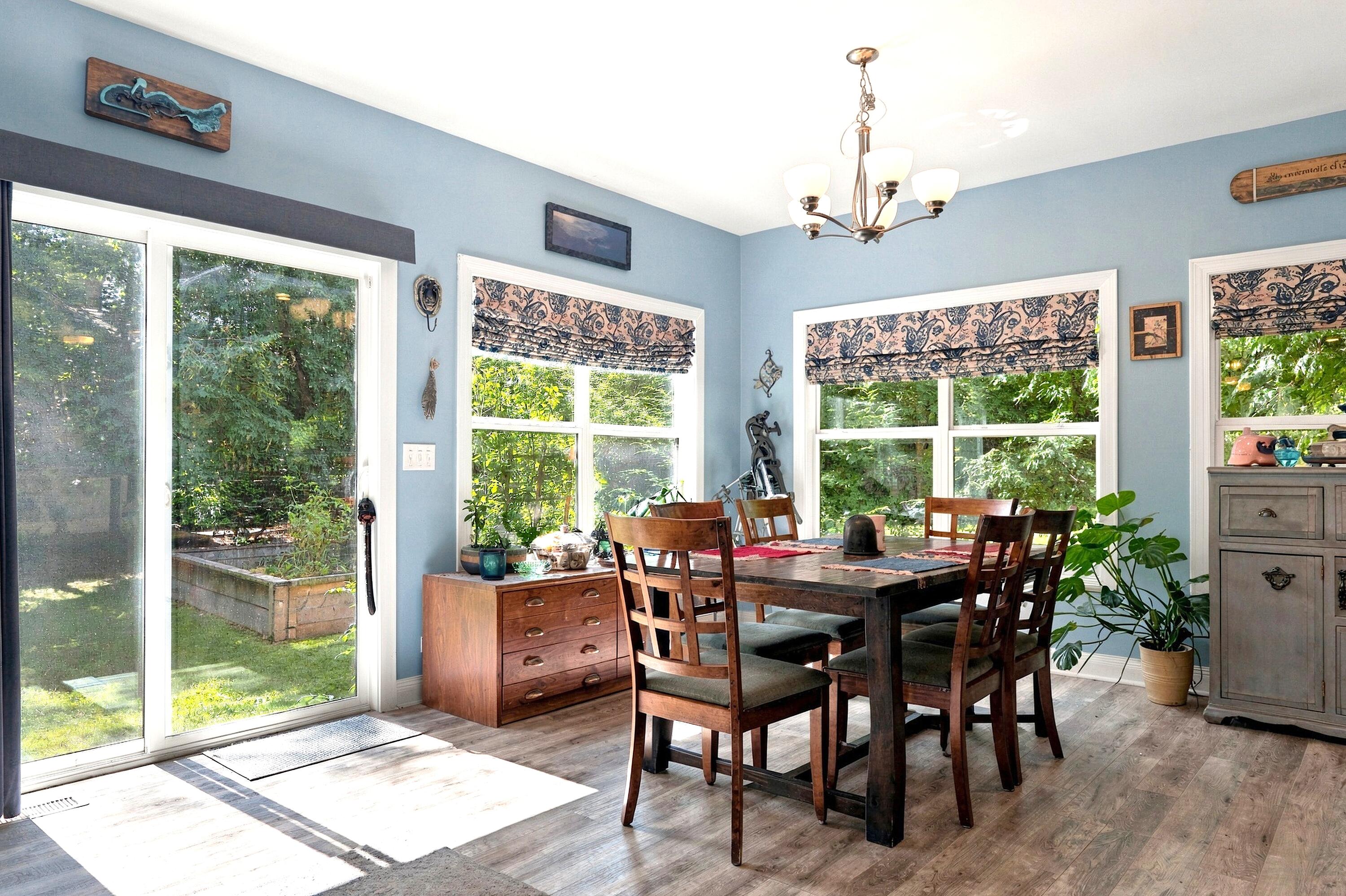 78 Menominee Road Williams Bay, WI 53191 - Photo 9 of 40 The sunny Dining Room overlooks the yard from walls of windows and opens to the side yard through the sliding glass door and beyond to the firepit.