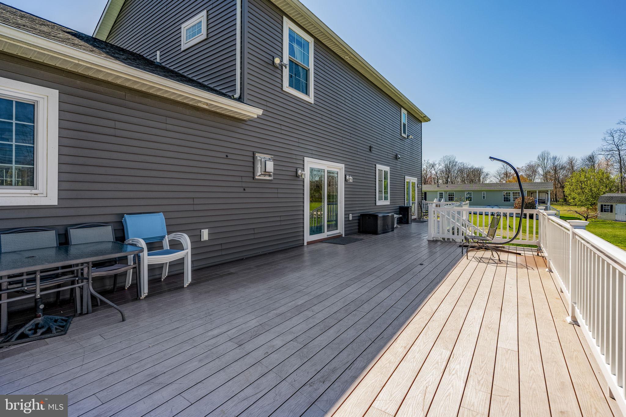 744 Lime Quarry Road Gap, PA 17527 - Photo 16 of 76 a view of a patio with couches chairs and wooden floor