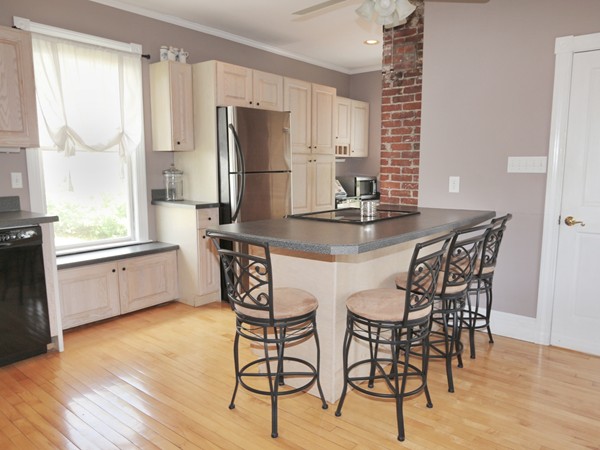 66 Winter Street Franklin, MA 02038 - Photo 21 of 30 a kitchen with stainless steel appliances a dining table chairs and wooden floor