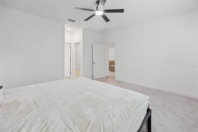 a bedroom with a bed and cabinets