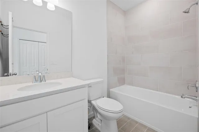 a bathroom with a sink a toilet and bathtub