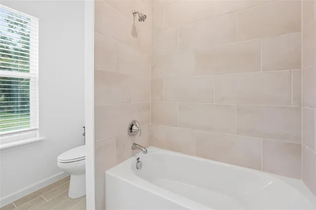 a white bath tub sitting next to a white toilet