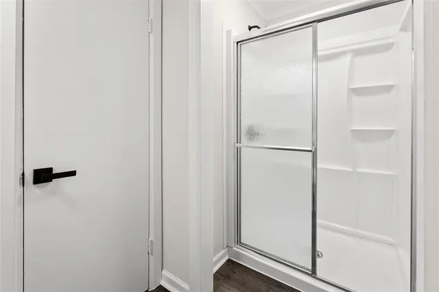 a bathroom with a glass shower door