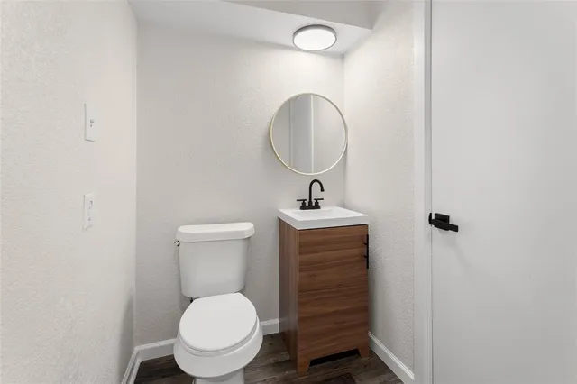 a bathroom with a toilet sink and a mirror