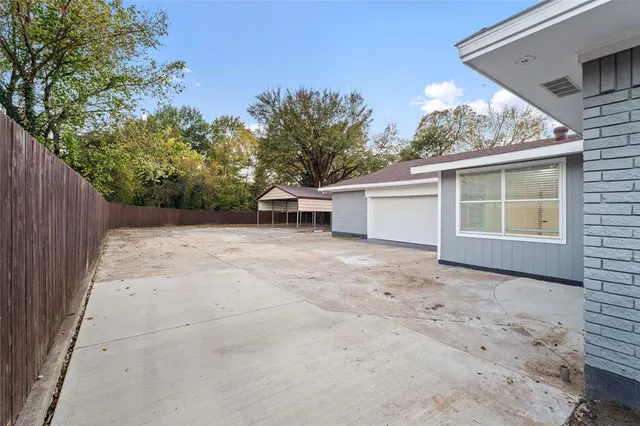 a view of a house with a backyard and a garage