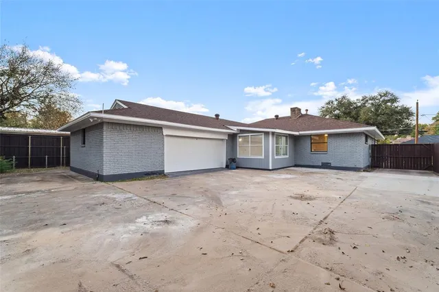 a view of a house with a space and a garage