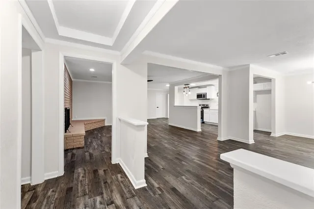 a view of a kitchen with wooden floor and a sink