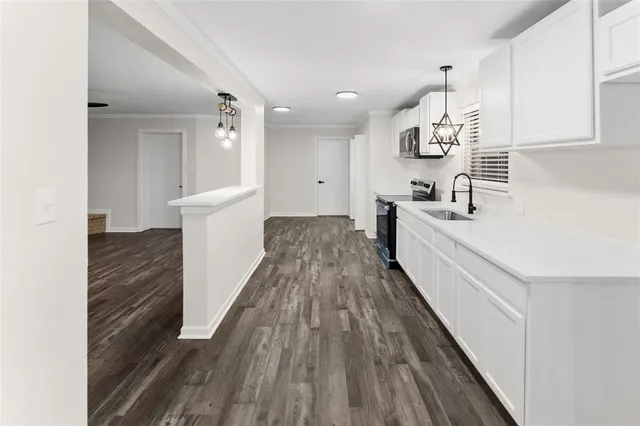 a view of a kitchen with wooden floor