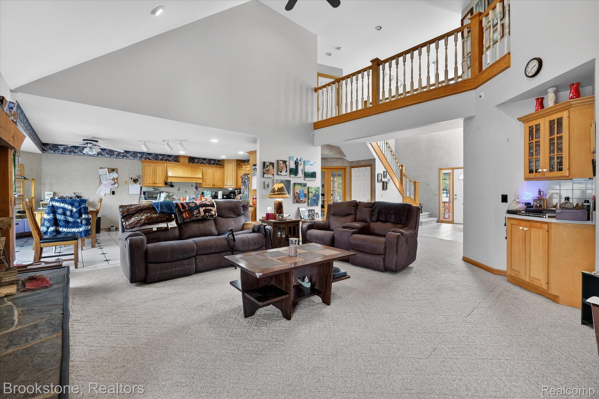 5163 Country Squire Road Dryden, MI 48428 - Photo 17 of 64 Living room featuring light colored carpet, stairs, bar area, recessed lighting, and a high ceiling