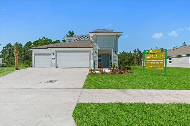 a front view of a house with a yard and a garage