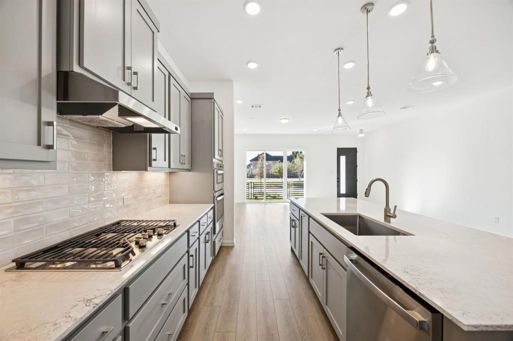 1164 Daybreak Drive Allen, TX 75013 - Photo 11 of 28 a kitchen with kitchen island a sink stove top oven and cabinets