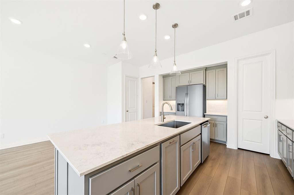 1164 Daybreak Drive Allen, TX 75013 - Photo 12 of 28 a kitchen with a sink stove and cabinets