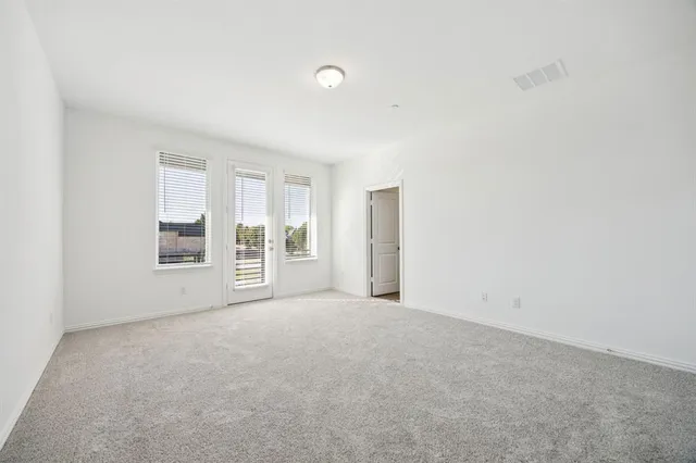 an empty room with closet and natural light