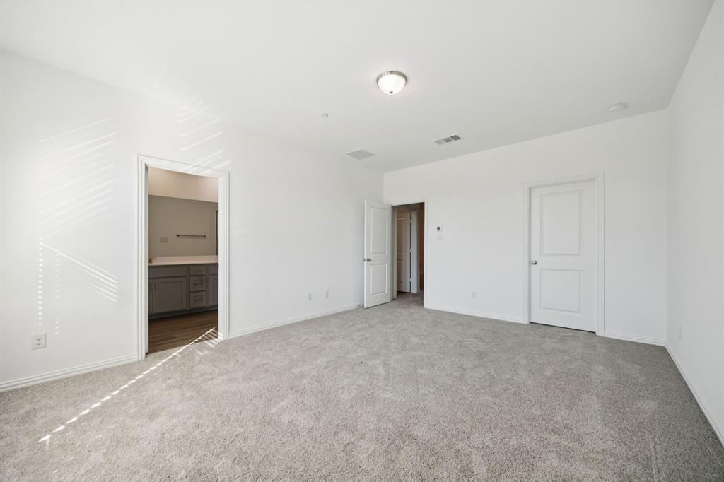 1164 Daybreak Drive Allen, TX 75013 - Photo 18 of 28 an empty room with closet and natural light