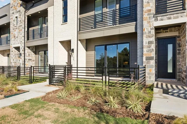 front view of a brick house with large windows