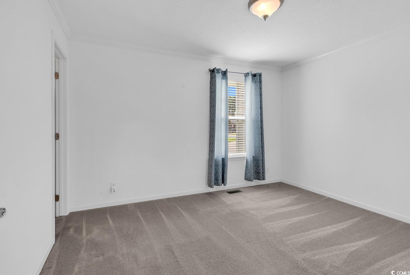 301 Walden Lake Road Conway, SC 29526 - Photo 11 of 37 Carpeted spare room with ornamental molding