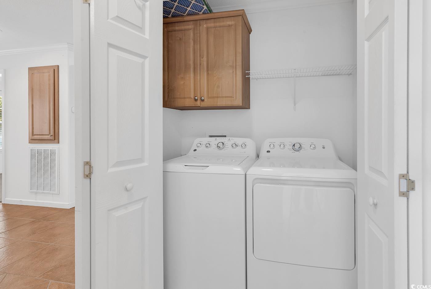301 Walden Lake Road Conway, SC 29526 - Photo 14 of 37 Laundry room with cabinet space, washing machine and clothes dryer, and ornamental molding