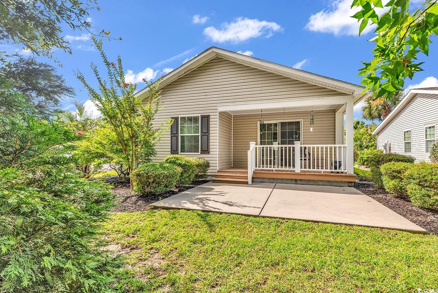 301 Walden Lake Road Conway, SC 29526 - Photo 22 of 37 Back of property with a yard, covered porch, and a patio