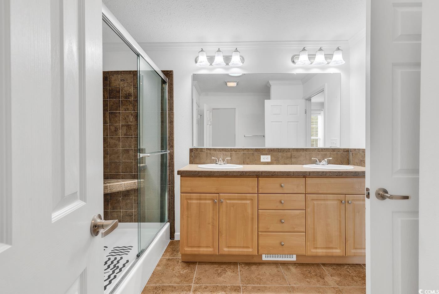 301 Walden Lake Road Conway, SC 29526 - Photo 8 of 37 Full bath featuring a shower stall, double vanity, ornamental molding, and tile patterned floors