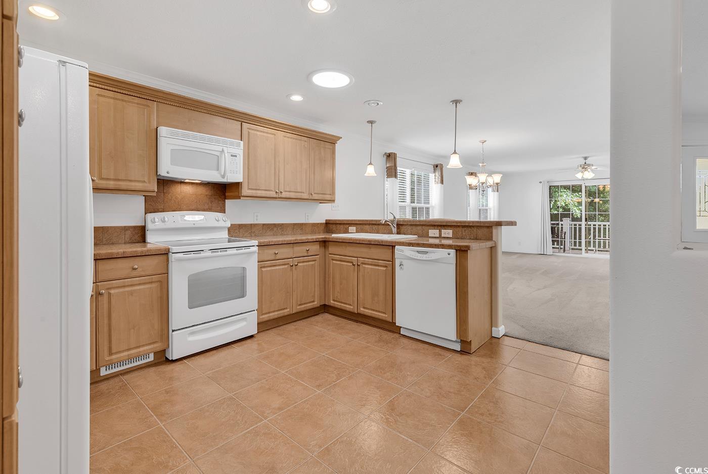 301 Walden Lake Road Conway, SC 29526 - Photo 10 of 37 Kitchen with white appliances, a peninsula, plenty of natural light, recessed lighting, and light tile patterned floors