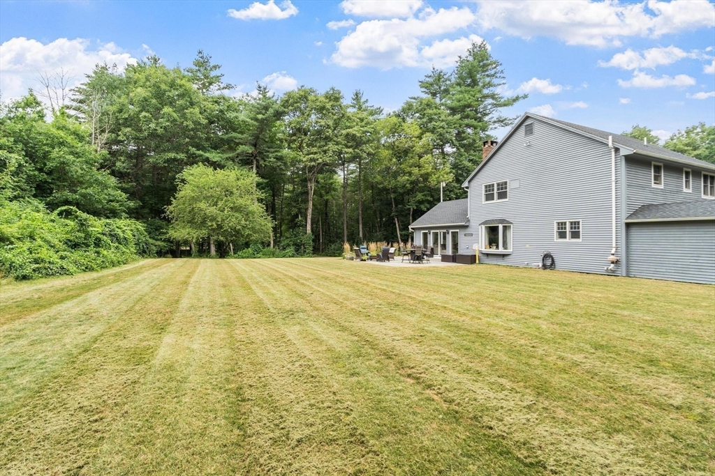 241 Reservoir Road Lunenburg, MA 01462 - Photo 14 of 40 a view of a house with a backyard