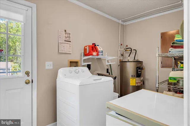 a spacious bedroom with a bed and chandelier