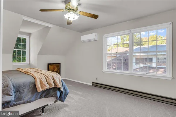a bedroom with furniture and a window