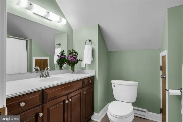 a backyard of a house with plants and large trees