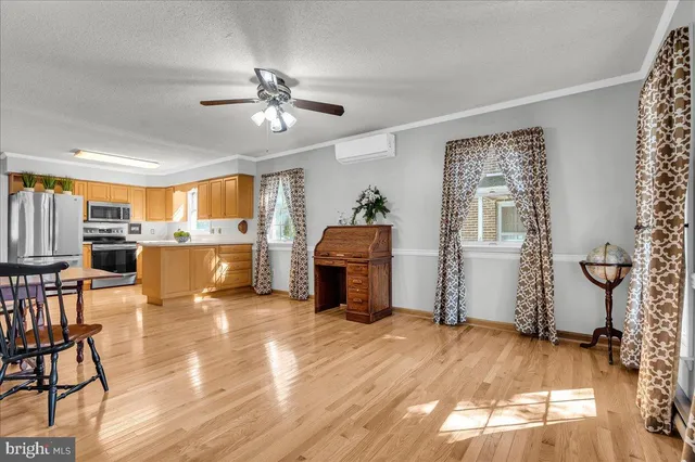 a living room with furniture and a open kitchen view