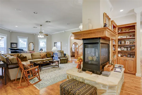 a living room with furniture a couch and wooden floor