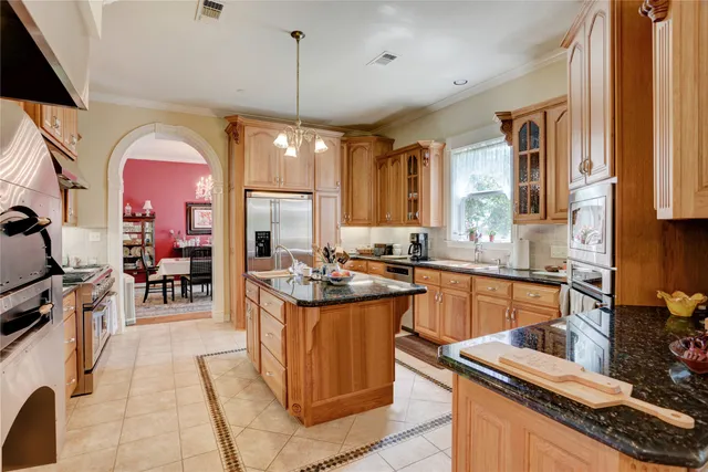 a kitchen with lots of counter top space and stainless steel appliances