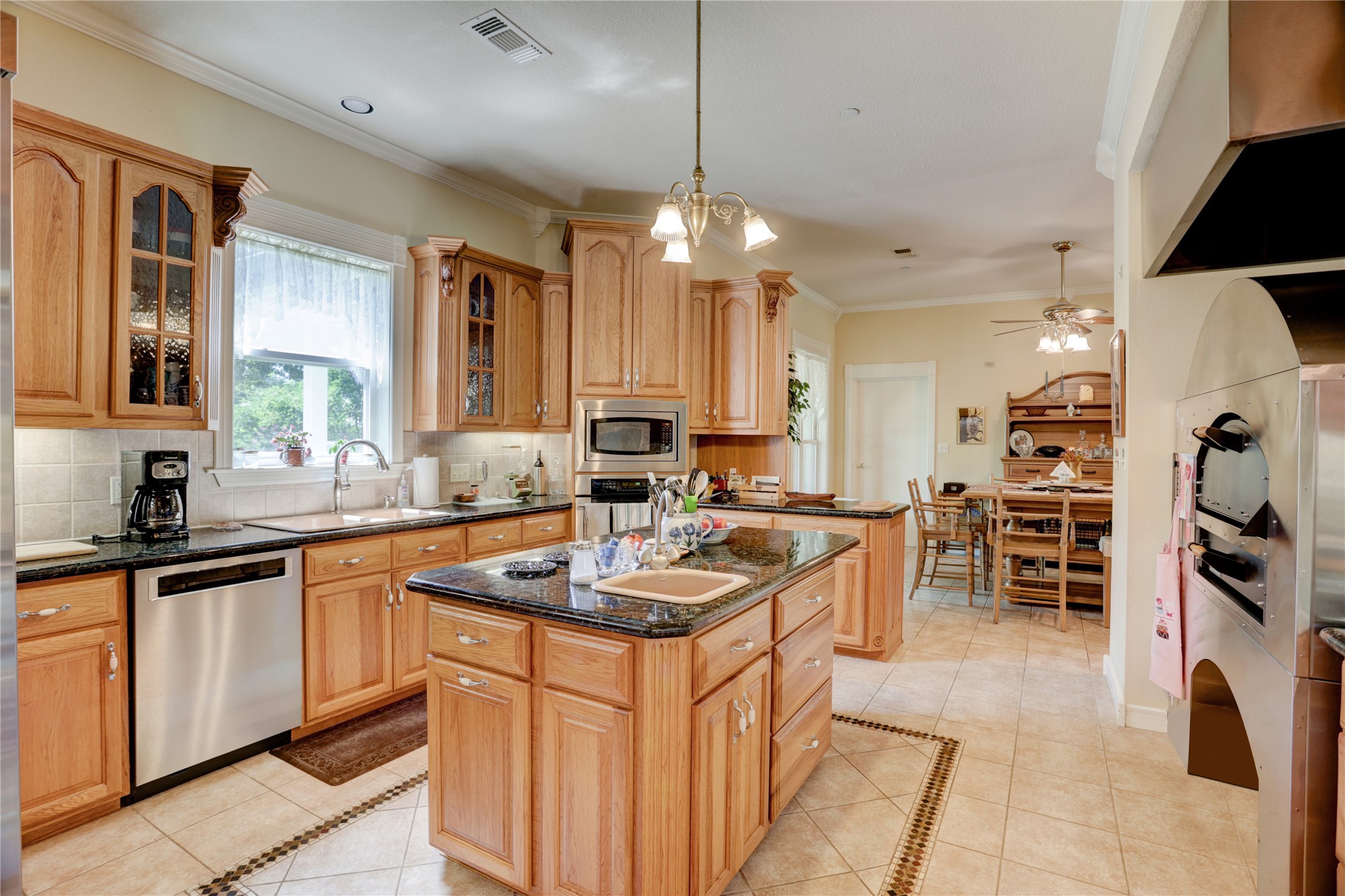 4854 Coshatte Road Bellville, TX 77418 - Photo 19 of 52 a kitchen that has a lot of cabinets a sink and appliances in it