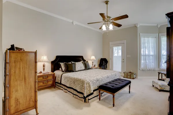 a bedroom with a bed and a chandelier