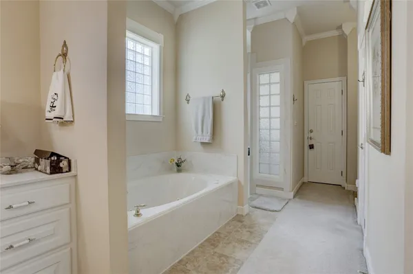 a bathroom with a bathtub and a window
