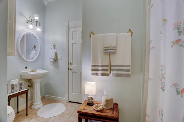 a bathroom with a sink toilet and a mirror