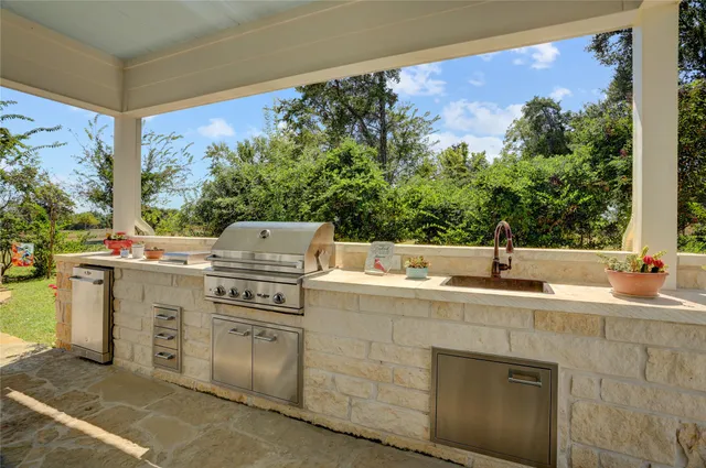 a kitchen with a sink stove and cabinets