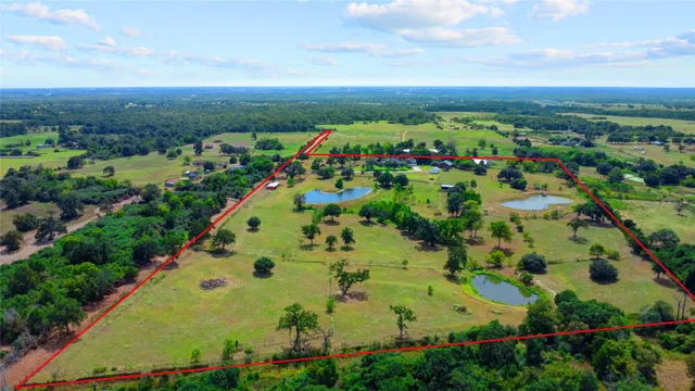 an aerial view of residential houses with outdoor space and street view