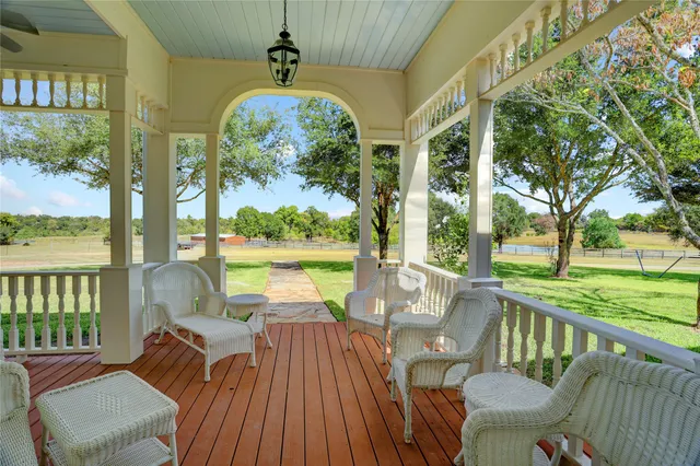 a view of a chairs and table in patio with a lake view
