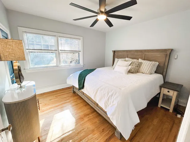 a bedroom with a large bed and a window