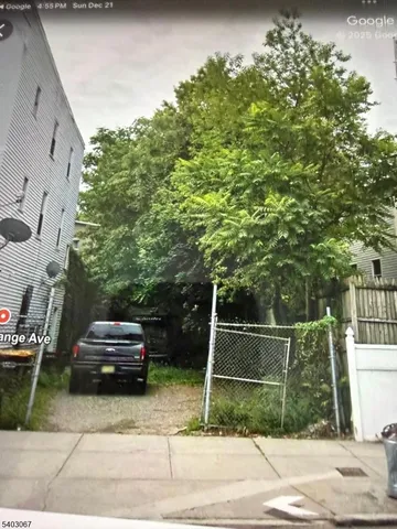 a view of a door and a car parked on the side of the road