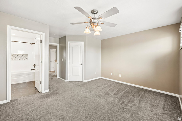 3215 West 450 North West Point, UT 84015 - Photo 15 of 40 Spacious room with gray carpeting and light-toned walls