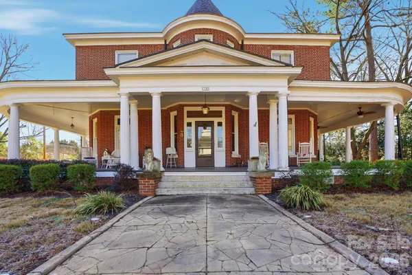 front view of a brick house with a large windows
