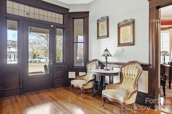 a living room with furniture and two window
