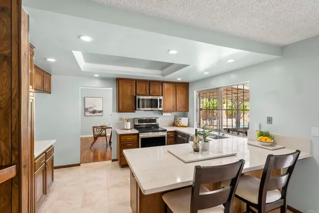 a living room with furniture floor to ceiling window and wooden floor