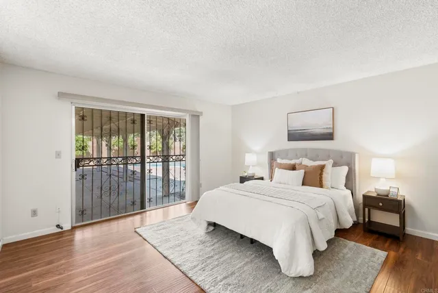 a bedroom with a bed a table and chair