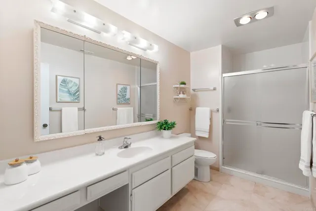 a view of walk in closet with clothes