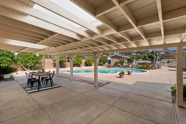 a view of a patio with table and chairs and plants