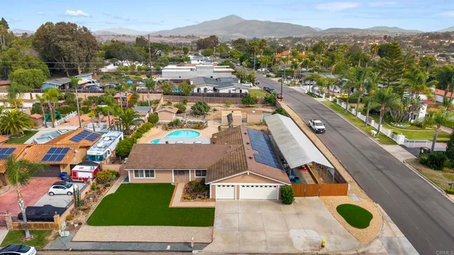an aerial view of residential houses with outdoor space
