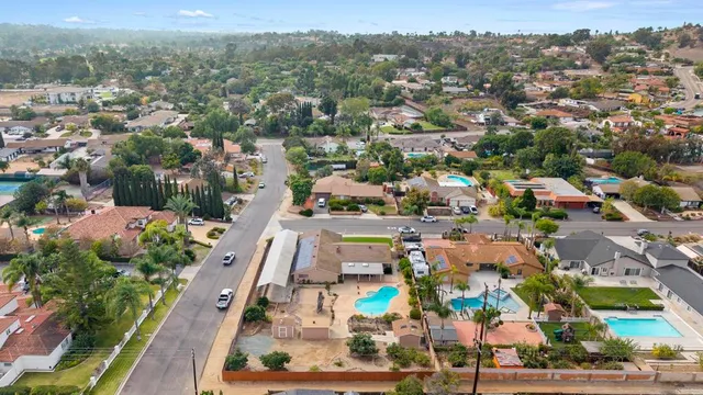an aerial view of residential houses with outdoor space