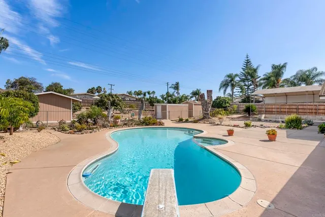 a front view of a house with a garden and plants